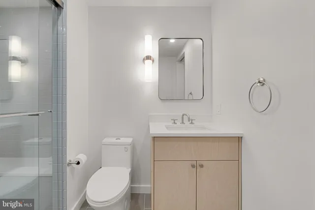 a bathroom with a shower and a mirror