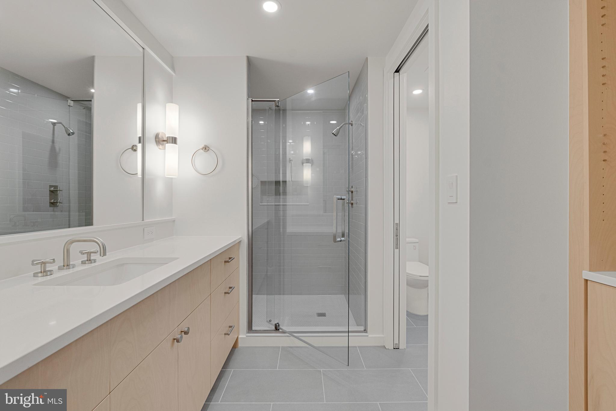 2706 Bartol Avenue Baltimore, MD 21209 - Photo 38 of 62 a bathroom with a shower sink double and mirror