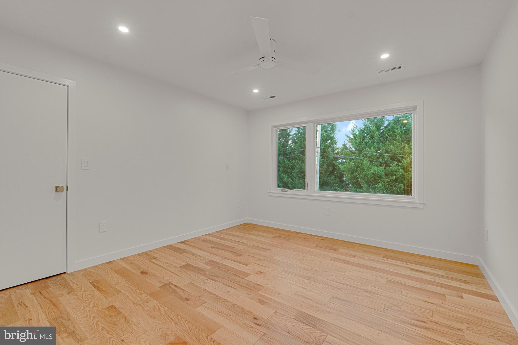 2706 Bartol Avenue Baltimore, MD 21209 - Photo 46 of 62 a view of an empty room with wooden floor and a window