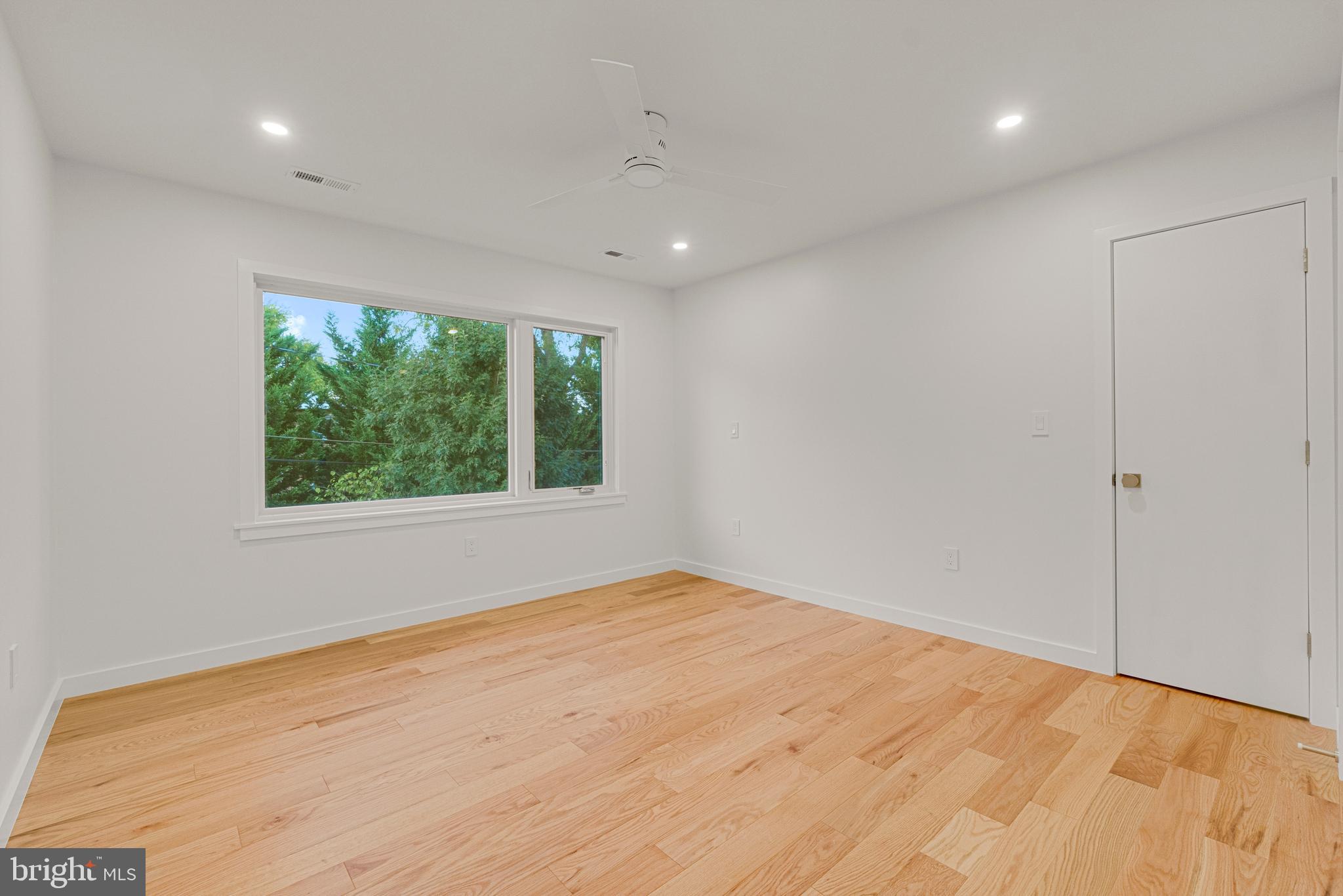 2706 Bartol Avenue Baltimore, MD 21209 - Photo 48 of 62 a view of an empty room with wooden floor and a window