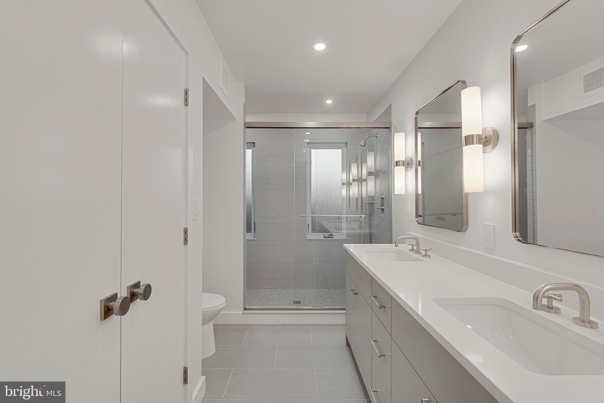 2706 Bartol Avenue Baltimore, MD 21209 - Photo 51 of 62 a bathroom with a shower sink and mirror