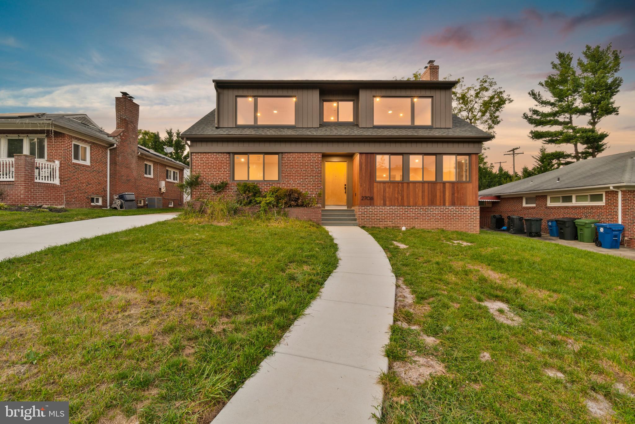 2706 Bartol Avenue Baltimore, MD 21209 - Photo 62 of 62 a front view of a brick house with a yard table and chairs