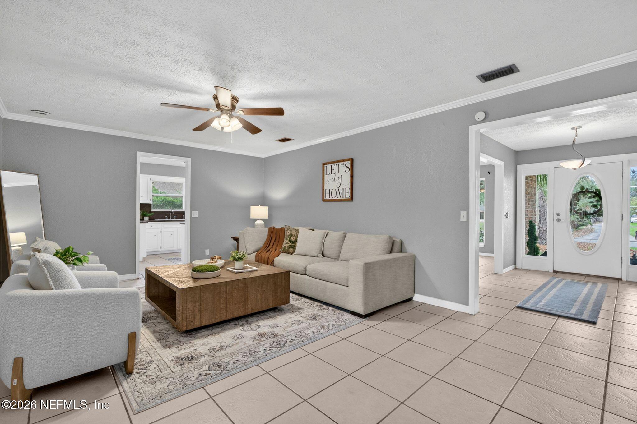 138 Ridgefield Court Orange Park, FL 32065 - Photo 11 of 64 a living room with furniture and a chandelier