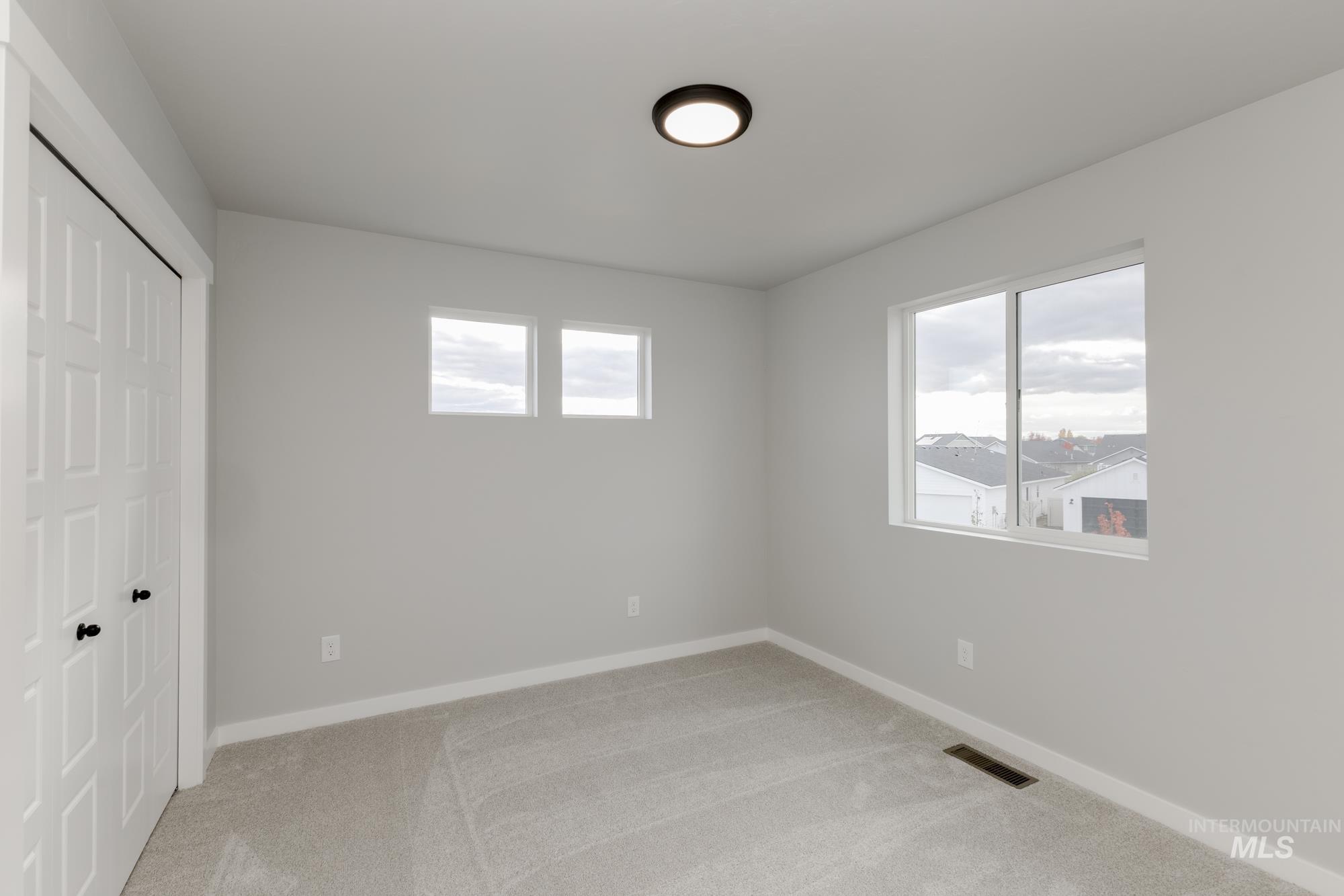 891 North Mirror Creek Way Meridian, ID 83642 - Photo 13 of 20 Unfurnished bedroom featuring a closet and light carpet