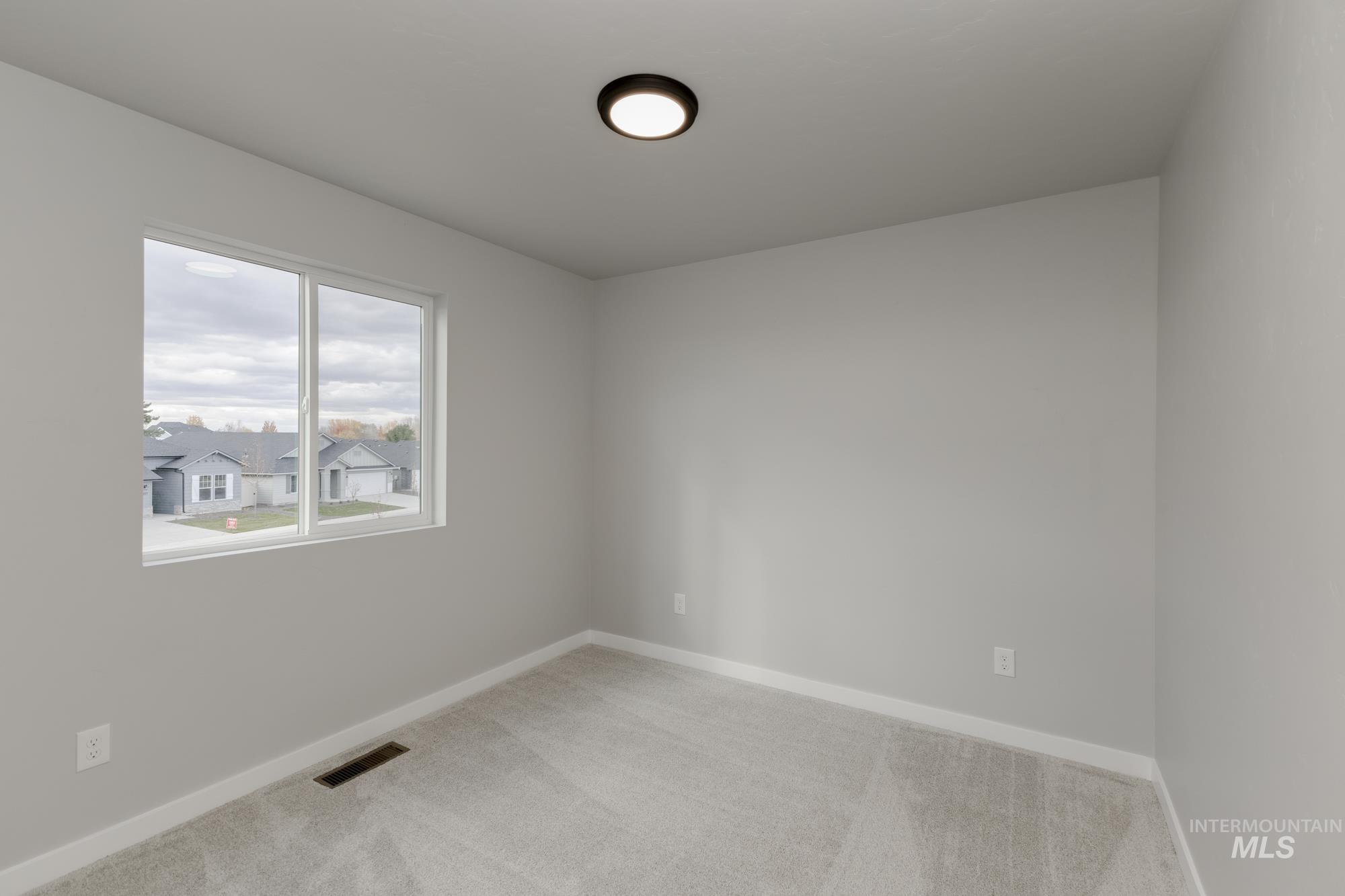 891 North Mirror Creek Way Meridian, ID 83642 - Photo 14 of 20 Carpeted spare room with baseboards