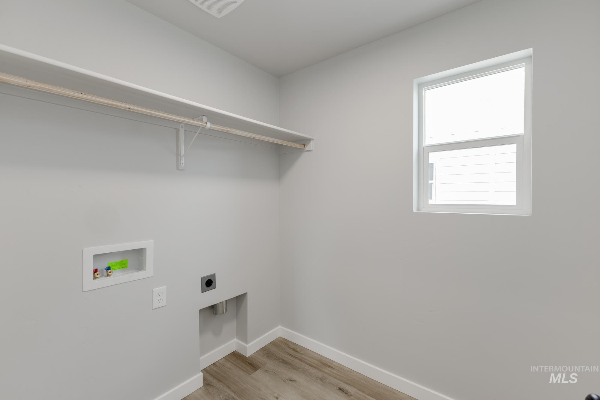 891 North Mirror Creek Way Meridian, ID 83642 - Photo 16 of 20 Laundry room featuring hookup for an electric dryer, light wood-type flooring, and washer hookup