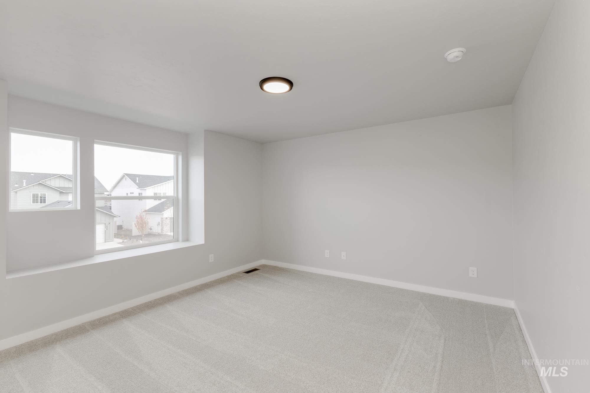 891 North Mirror Creek Way Meridian, ID 83642 - Photo 17 of 20 Spare room with light colored carpet and baseboards
