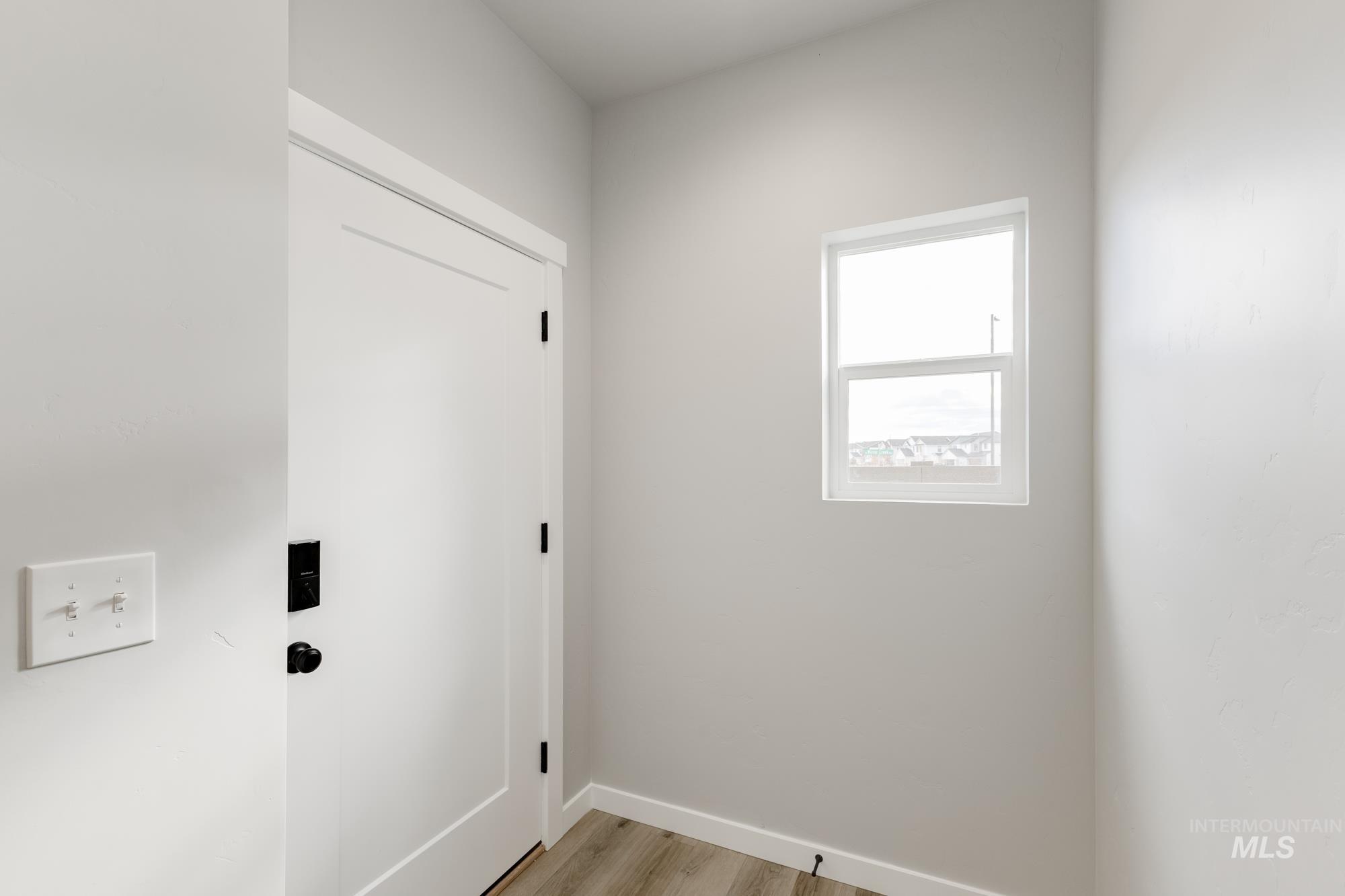 891 North Mirror Creek Way Meridian, ID 83642 - Photo 3 of 20 Laundry area with light wood-style flooring and baseboards