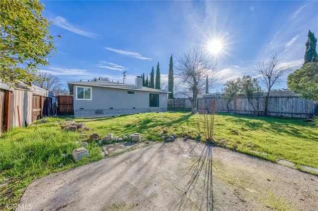 a view of a house with a yard and sitting area