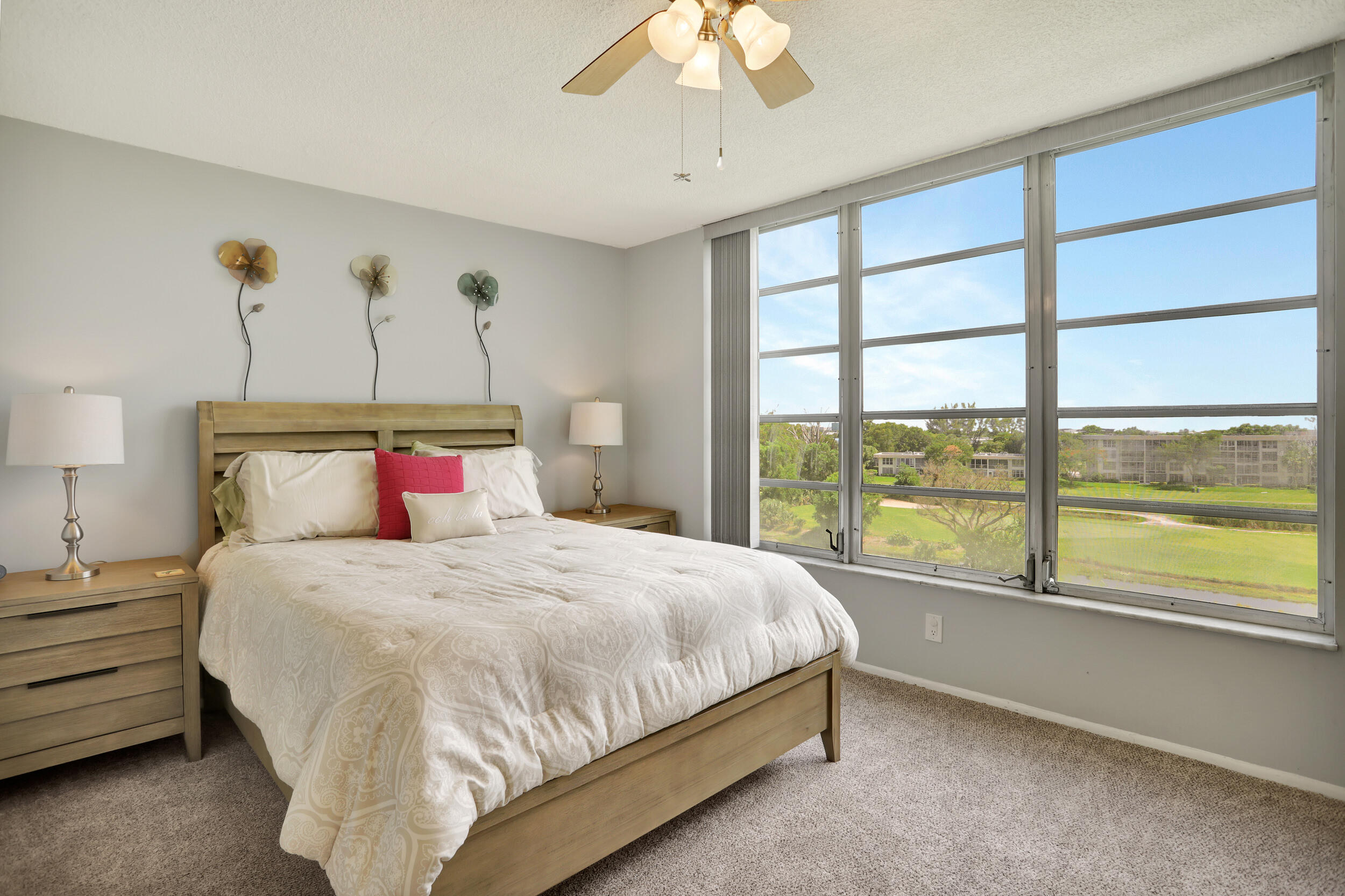 3001 South Course Drive, Unit 508 Pompano Beach, FL 33069 - Photo 15 of 36 a bedroom with a large bed and a large window