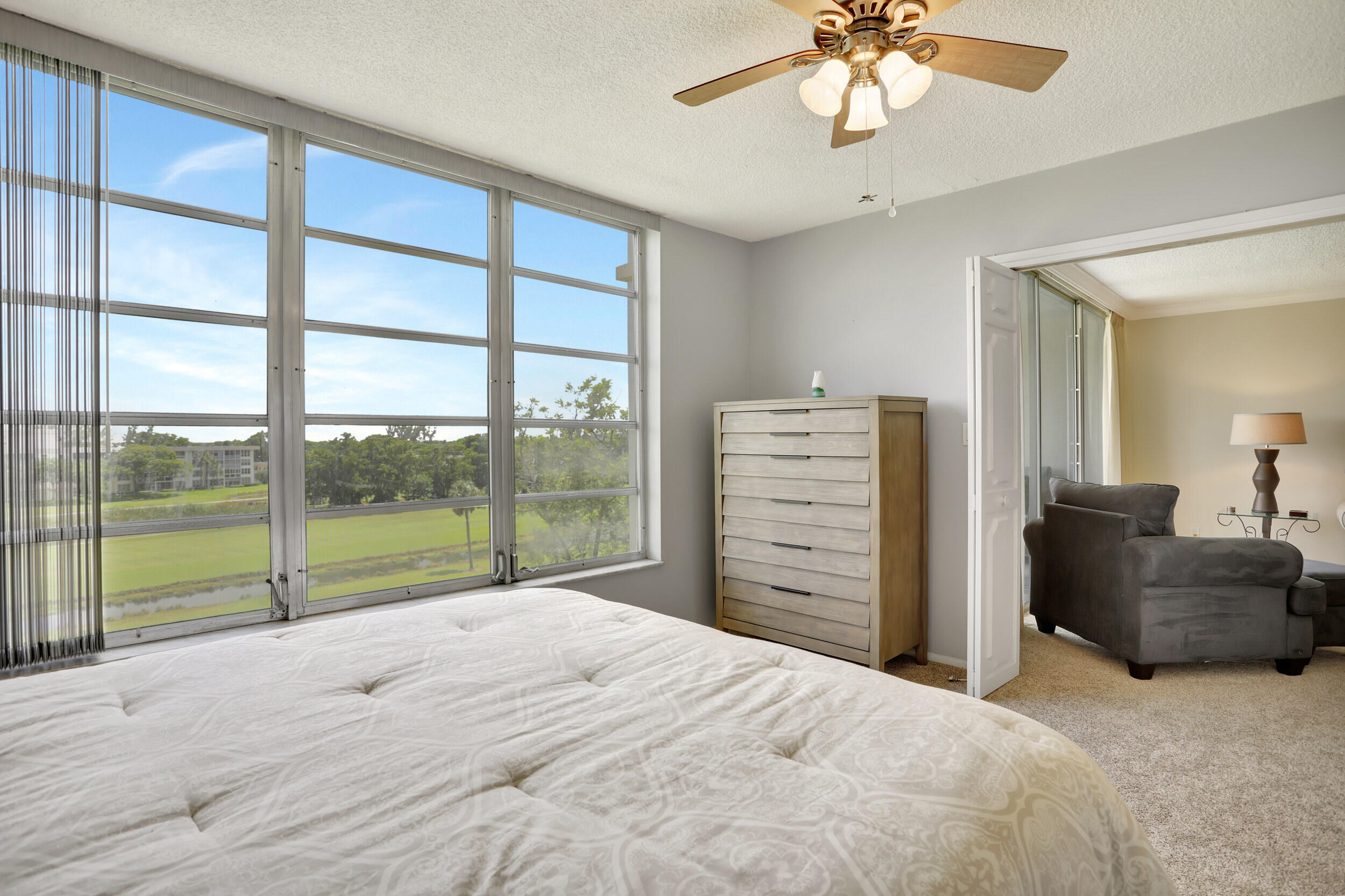 3001 South Course Drive, Unit 508 Pompano Beach, FL 33069 - Photo 16 of 36 a bedroom with a bed and a large window