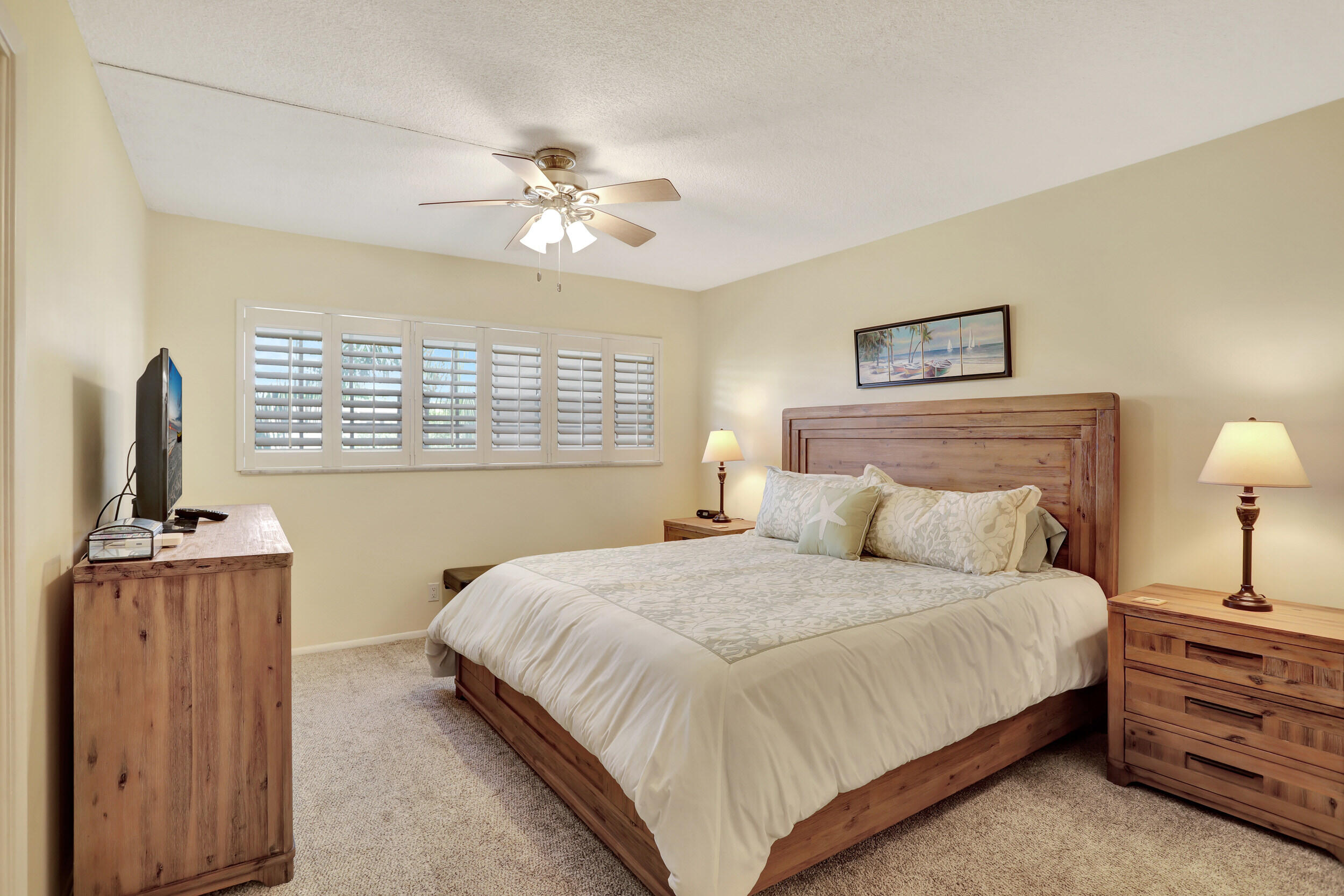 3001 South Course Drive, Unit 508 Pompano Beach, FL 33069 - Photo 20 of 36 a bedroom with a bed and a chandelier