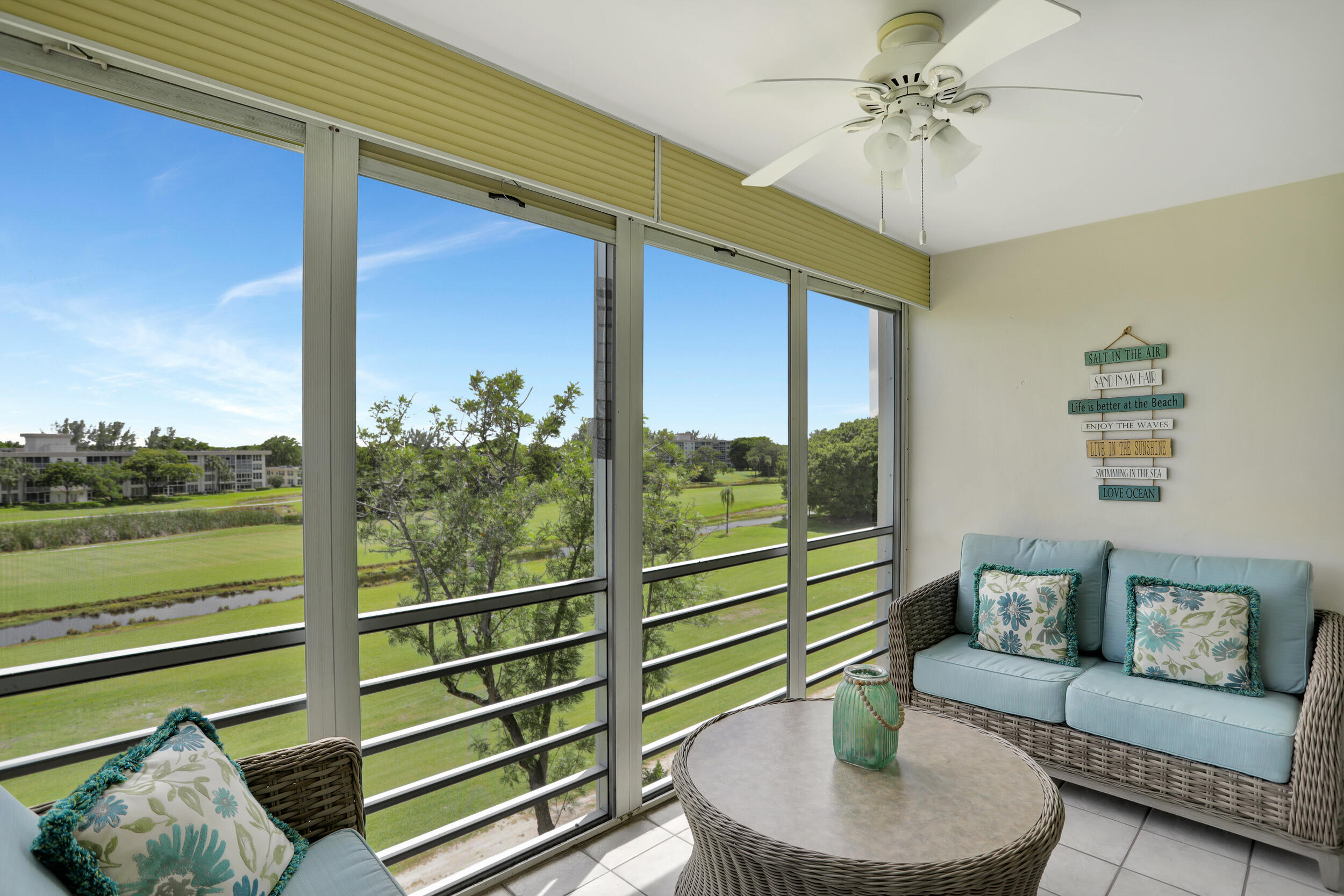 3001 South Course Drive, Unit 508 Pompano Beach, FL 33069 - Photo 28 of 36 a living room with furniture and a floor to ceiling window