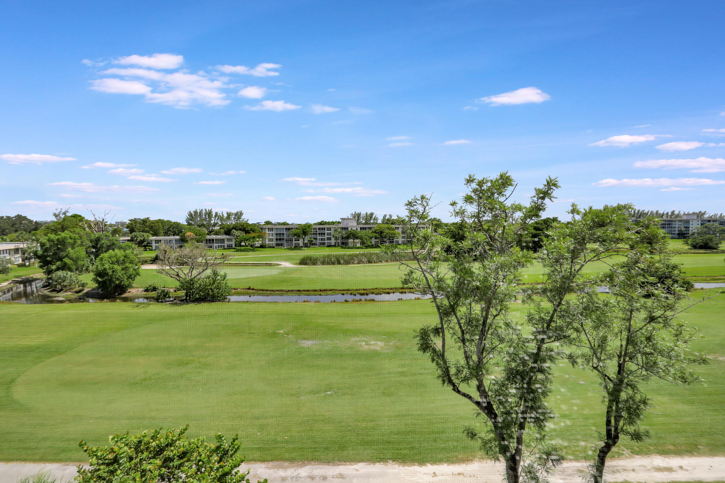 3001 South Course Drive, Unit 508 Pompano Beach, FL 33069 - Photo 29 of 36 a view of a lake with a yard