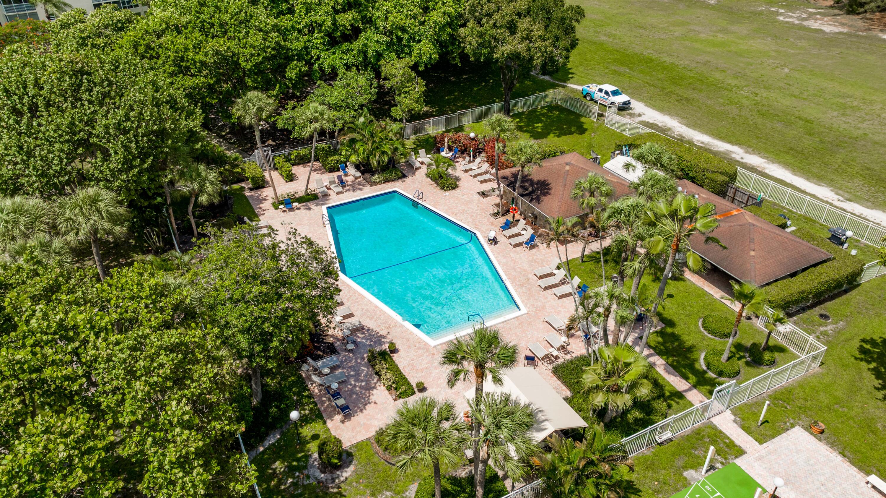 3001 South Course Drive, Unit 508 Pompano Beach, FL 33069 - Photo 30 of 36 an aerial view of a house with a yard and lake view