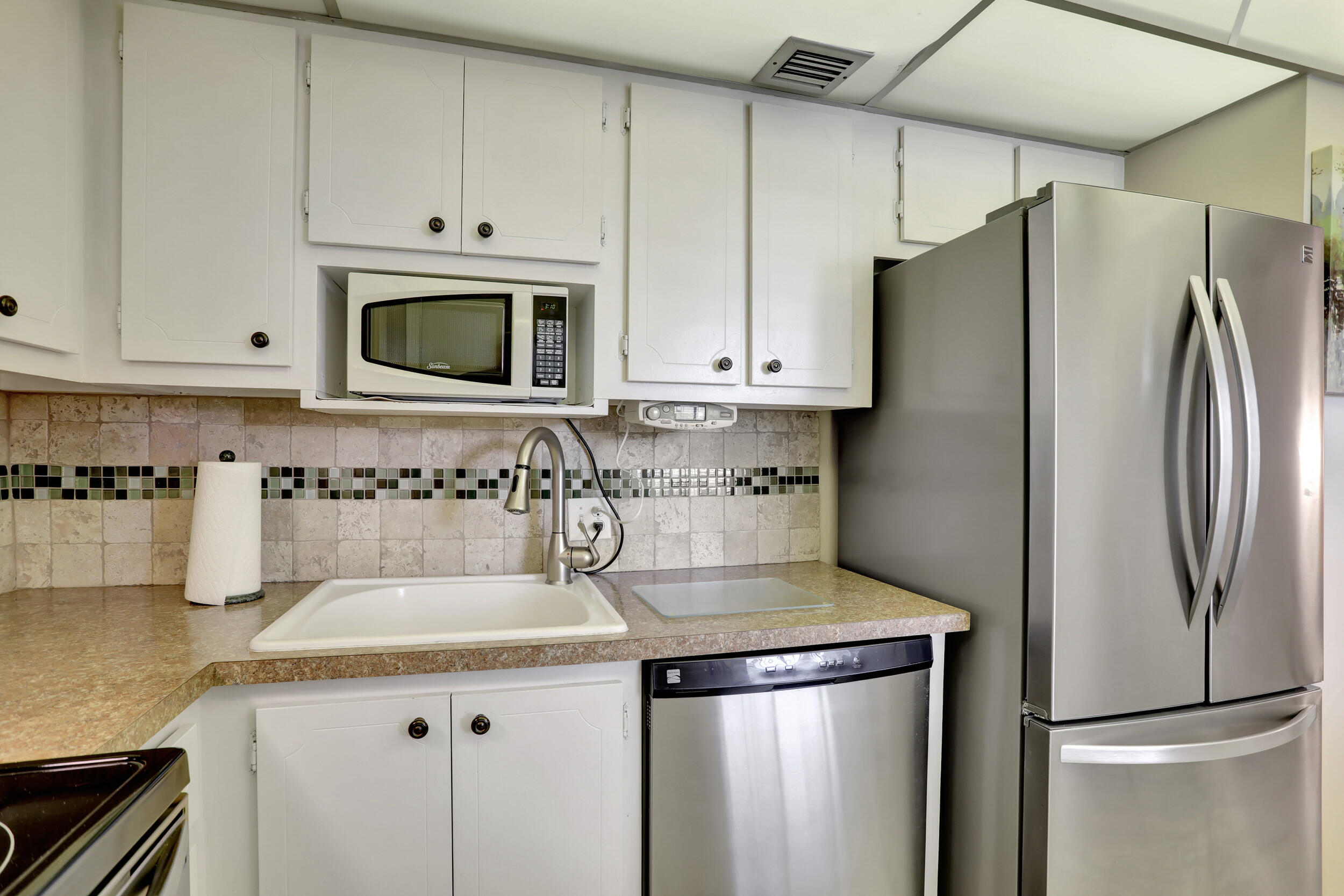 3001 South Course Drive, Unit 508 Pompano Beach, FL 33069 - Photo 6 of 36 a kitchen with stainless steel appliances granite countertop a refrigerator sink and cabinets