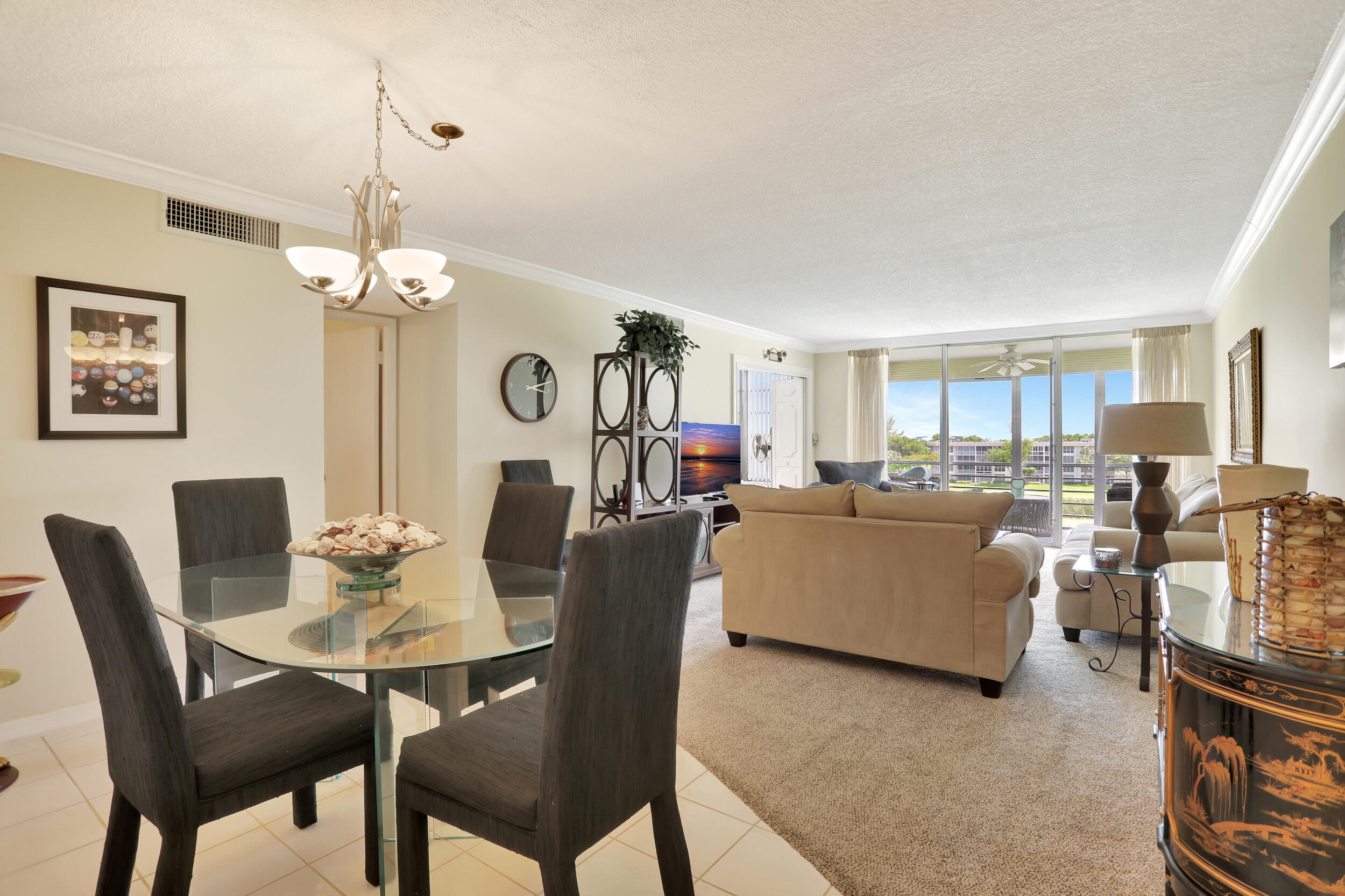 3001 South Course Drive, Unit 508 Pompano Beach, FL 33069 - Photo 7 of 36 a living room with furniture and a chandelier
