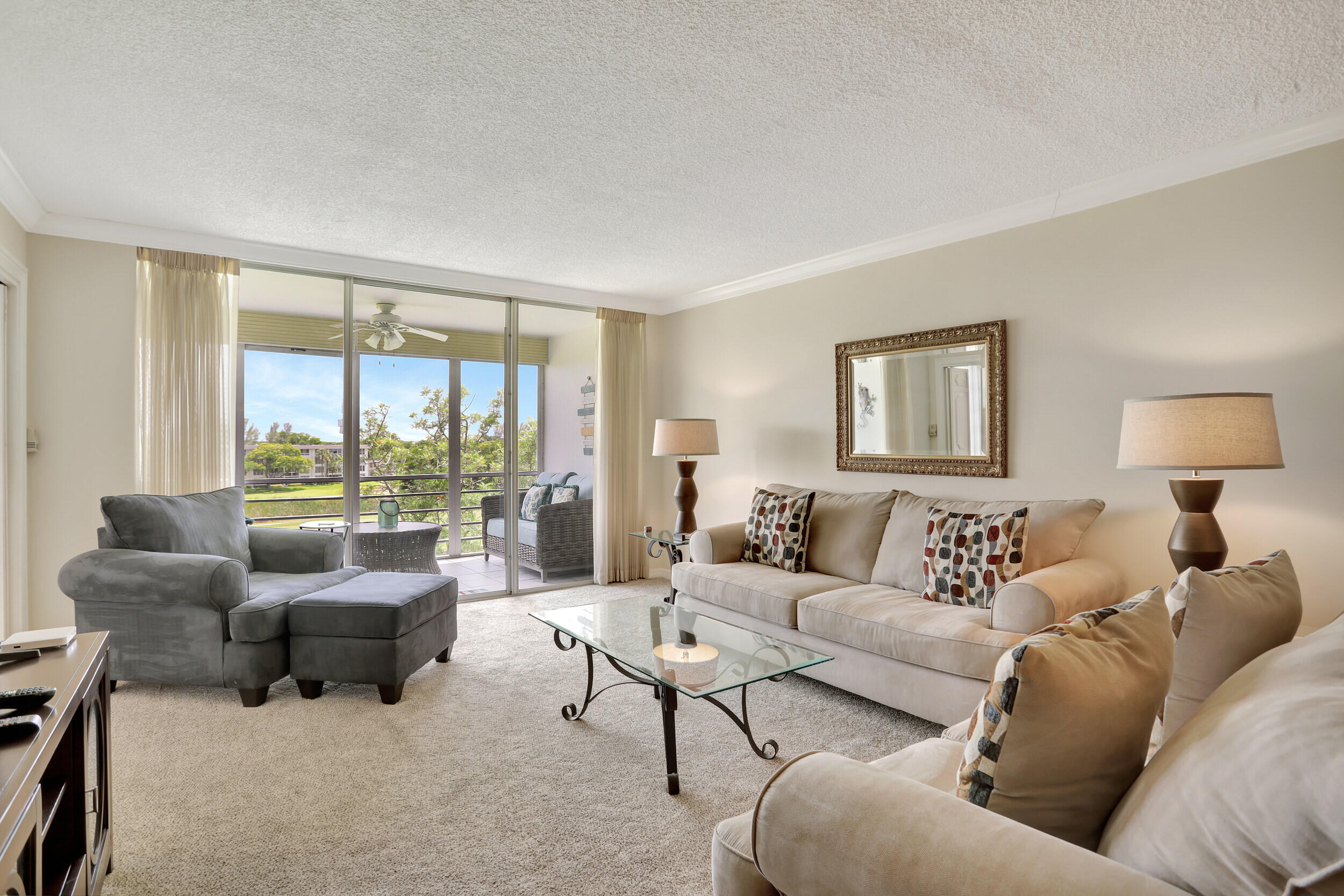 3001 South Course Drive, Unit 508 Pompano Beach, FL 33069 - Photo 10 of 36 a living room with furniture and a large window