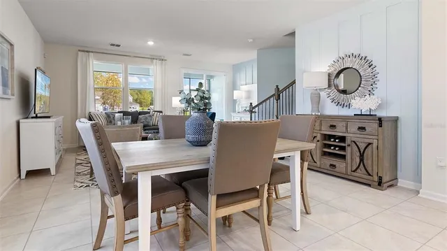 a view of a dining room with furniture and a large window