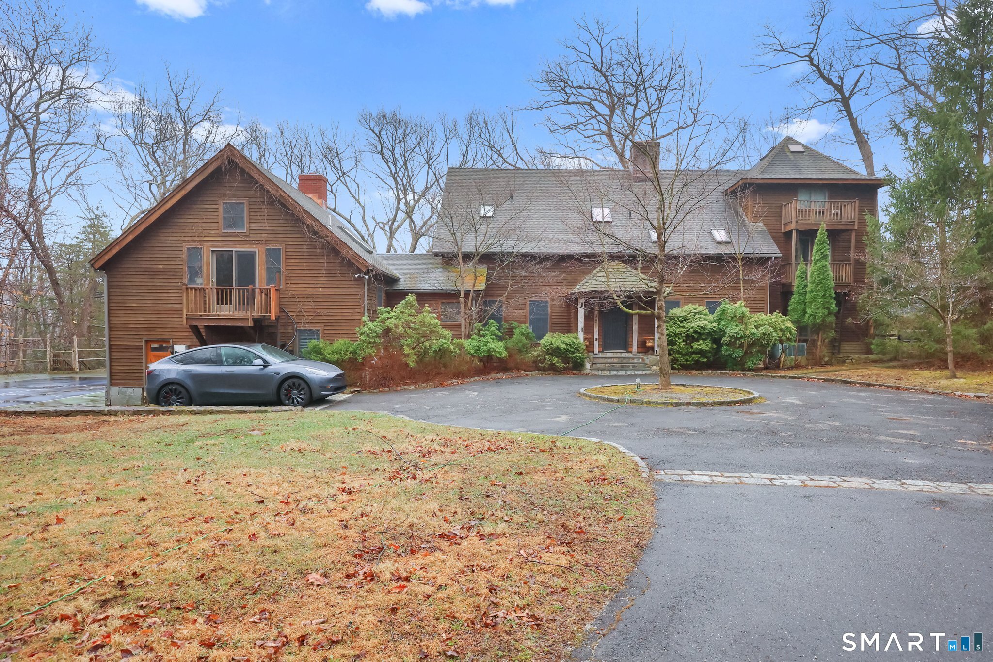 142 Seventy Acre Road Redding, CT 06896 - Photo 34 of 40 a front view of a house with a yard and garage