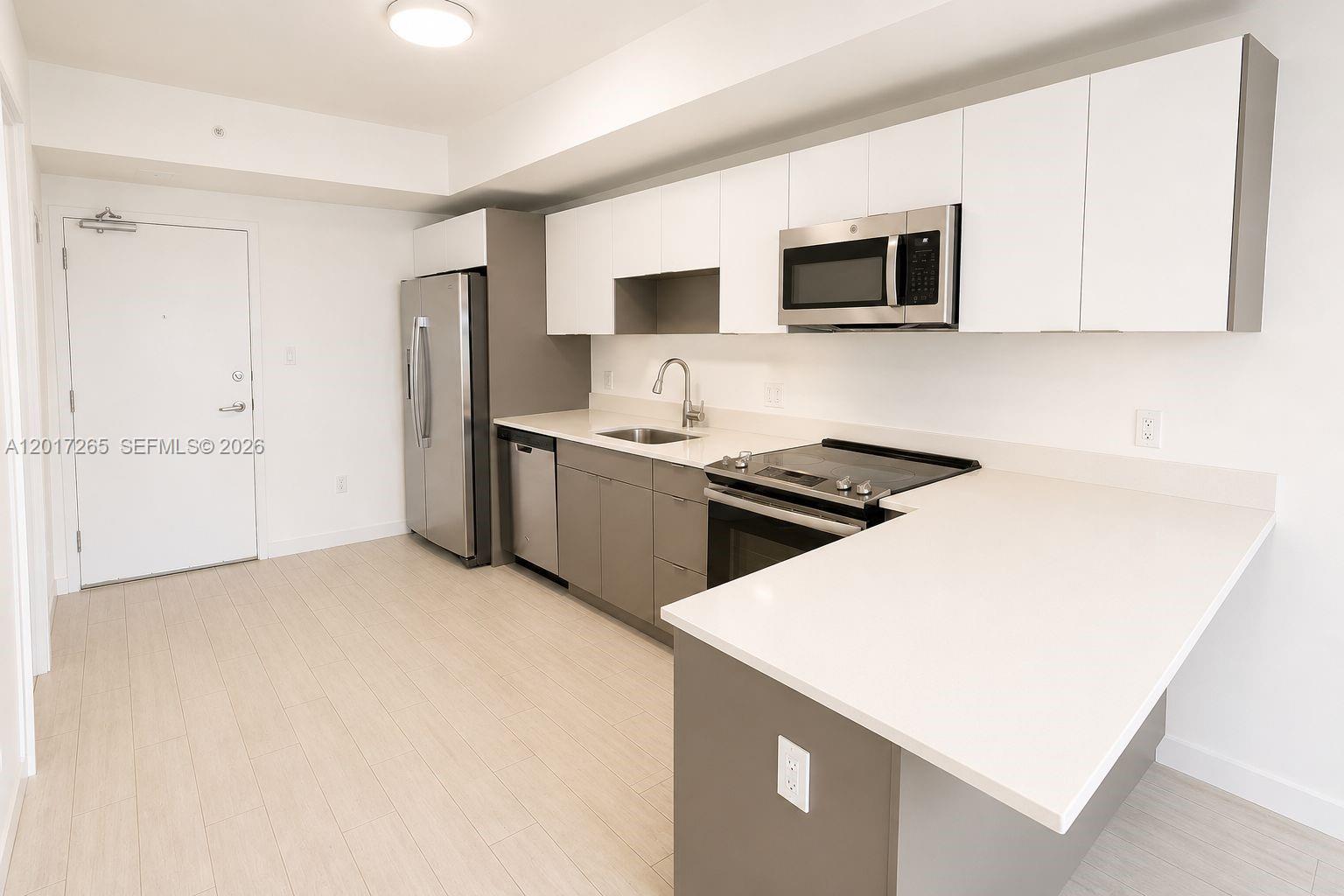 321 Northeast 26th Street, Unit 515 Miami, FL 33137 - Photo 2 of 7 a kitchen with stainless steel appliances a stove microwave and refrigerator
