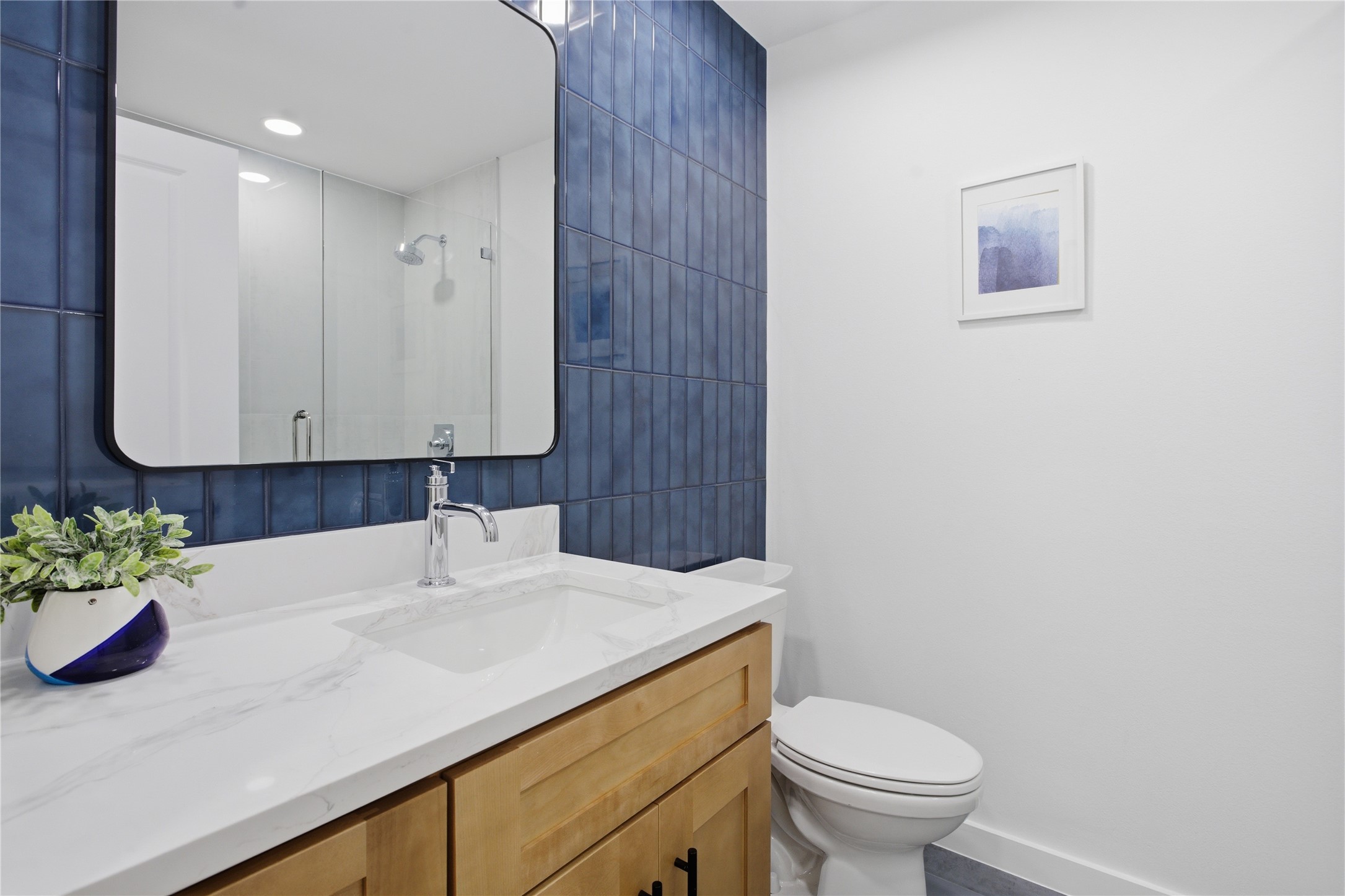 2110 Magazine Street Austin, TX 78727 - Photo 17 of 31 Modern bathroom featuring a wood-finish vanity with ample storage