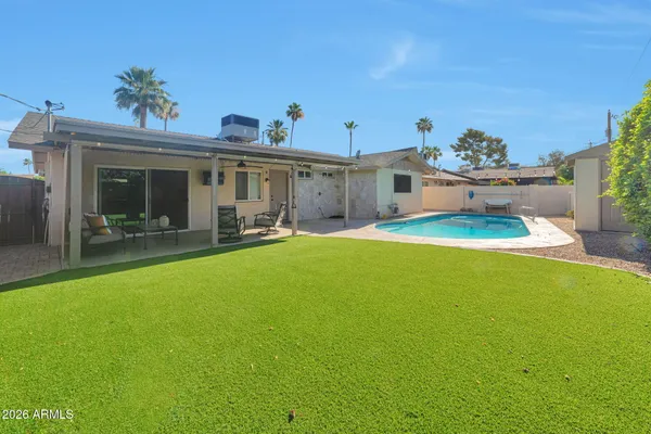 a view of a house with a backyard porch and furniture