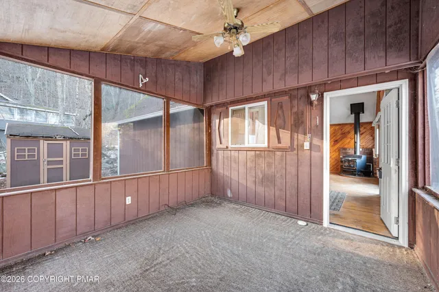 a view of a room with wooden floor and furniture