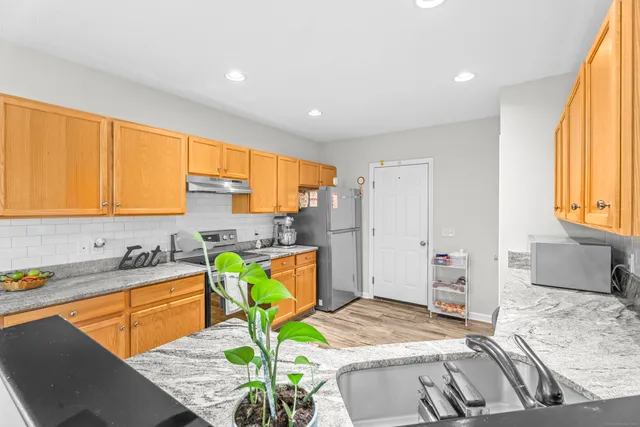 a bedroom with a bed a table and chair