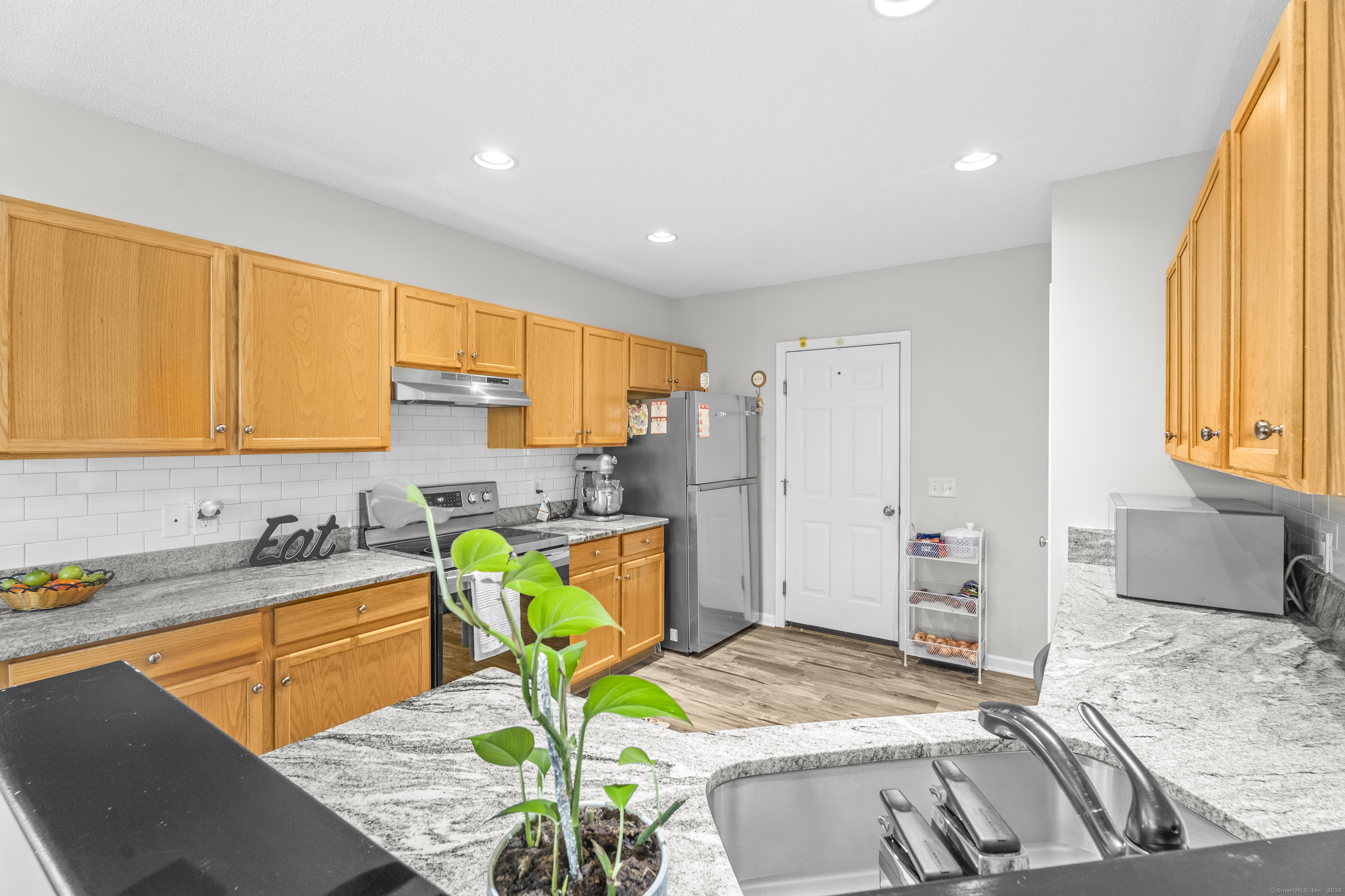 29 Primrose Lane, Unit 29 Suffield, CT 06078 - Photo 12 of 32 a bedroom with a bed a table and chair