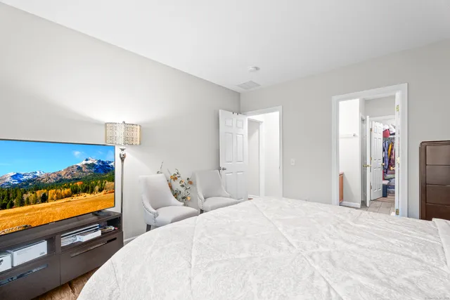 a bedroom with a bed and a flat screen tv