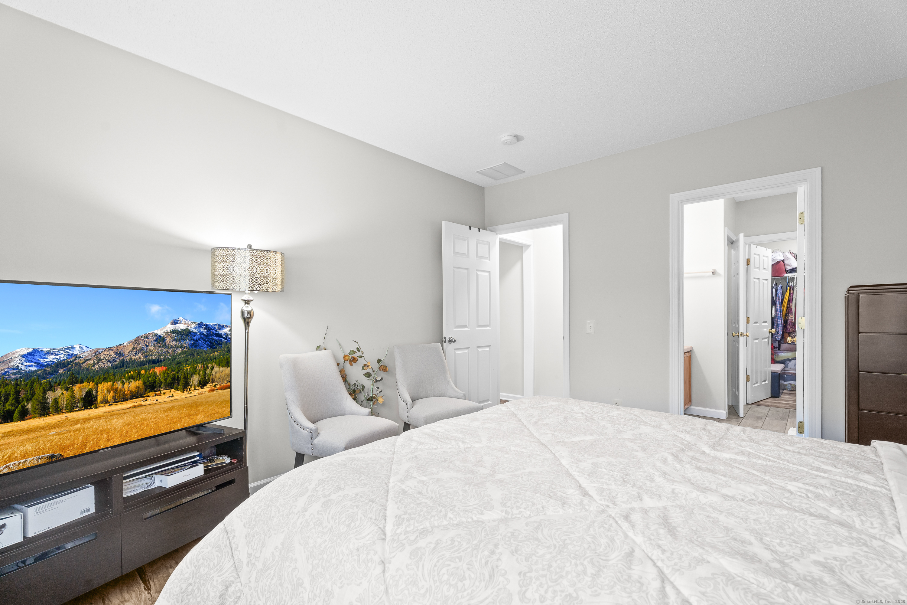 29 Primrose Lane, Unit 29 Suffield, CT 06078 - Photo 14 of 32 a bedroom with a bed and a flat screen tv