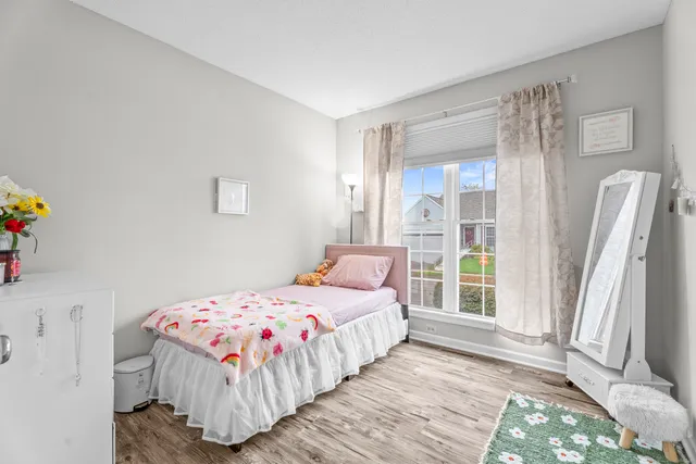 a bedroom with a bed and a large window