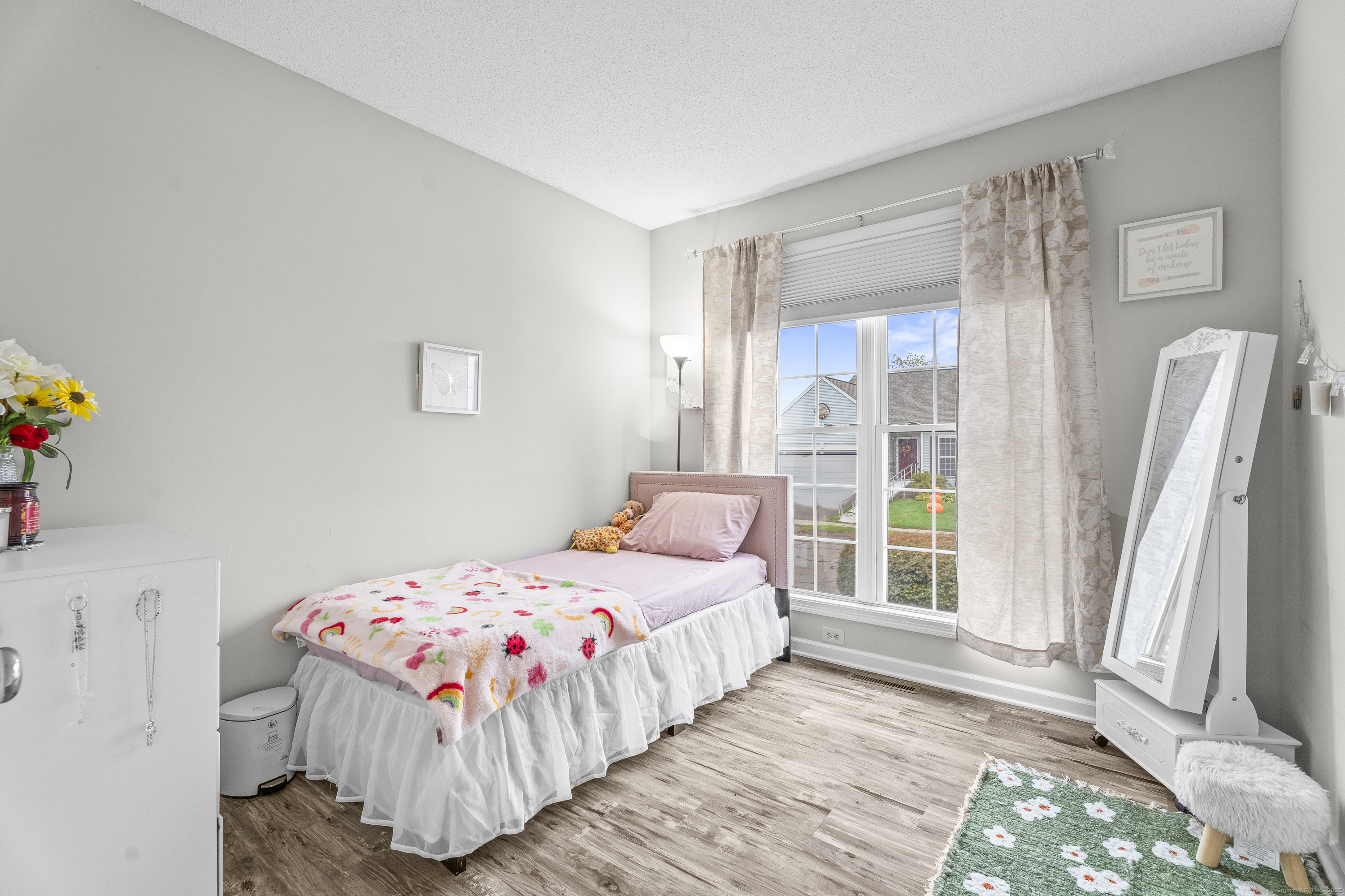 29 Primrose Lane, Unit 29 Suffield, CT 06078 - Photo 17 of 32 a bedroom with a bed and a large window