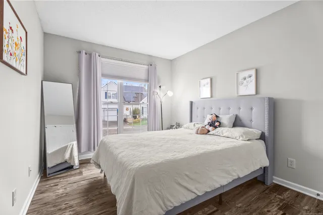 a bedroom with a bed and a large mirror