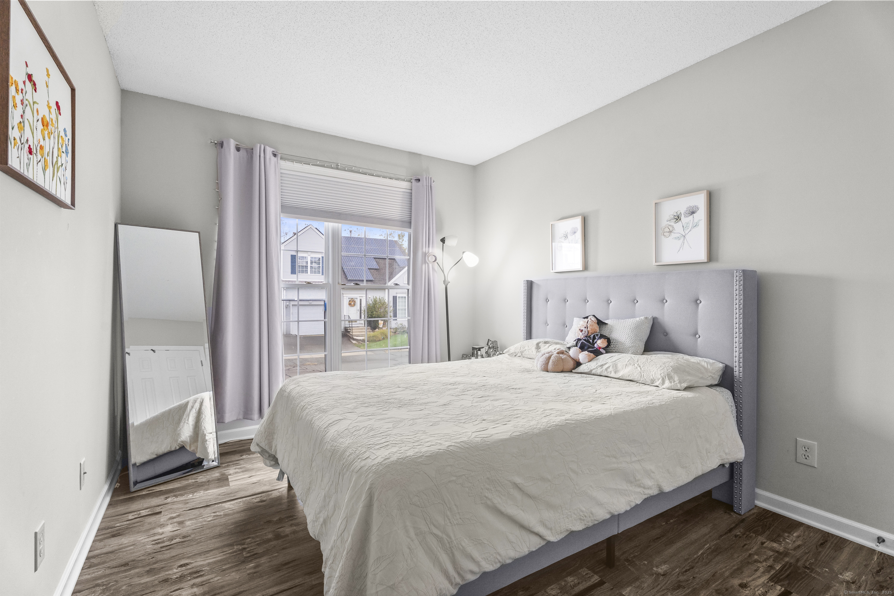 29 Primrose Lane, Unit 29 Suffield, CT 06078 - Photo 18 of 32 a bedroom with a bed and a large mirror