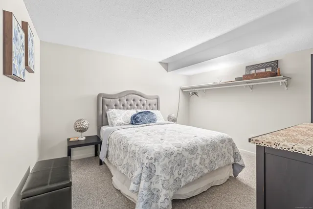 a bedroom with a bed and a table