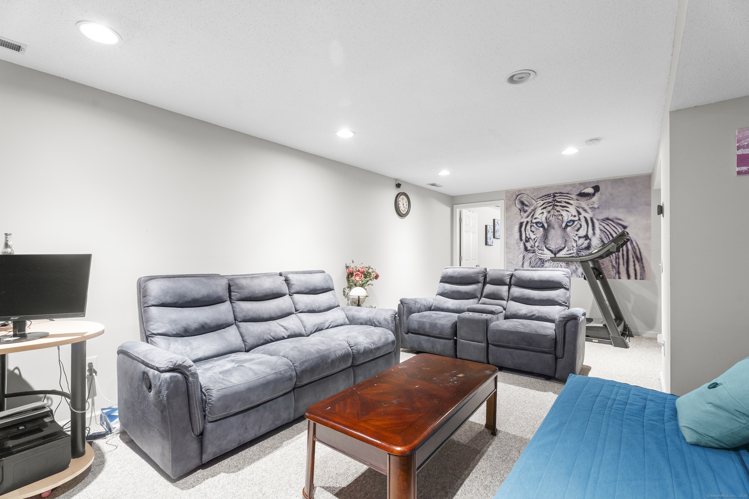 29 Primrose Lane, Unit 29 Suffield, CT 06078 - Photo 26 of 32 a living room with furniture and a flat screen tv