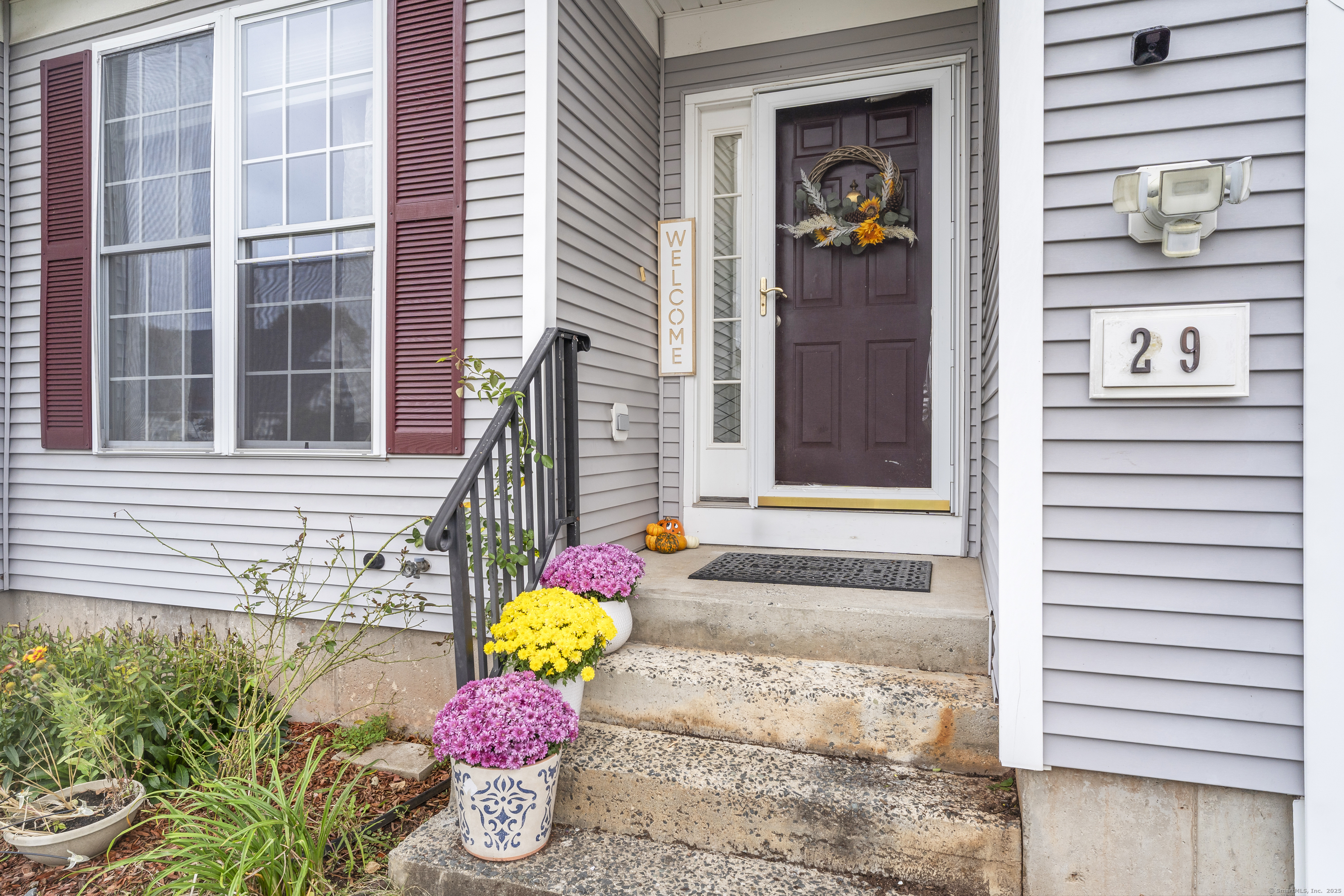 29 Primrose Lane, Unit 29 Suffield, CT 06078 - Photo 4 of 32 a front view of a house with a potted plant