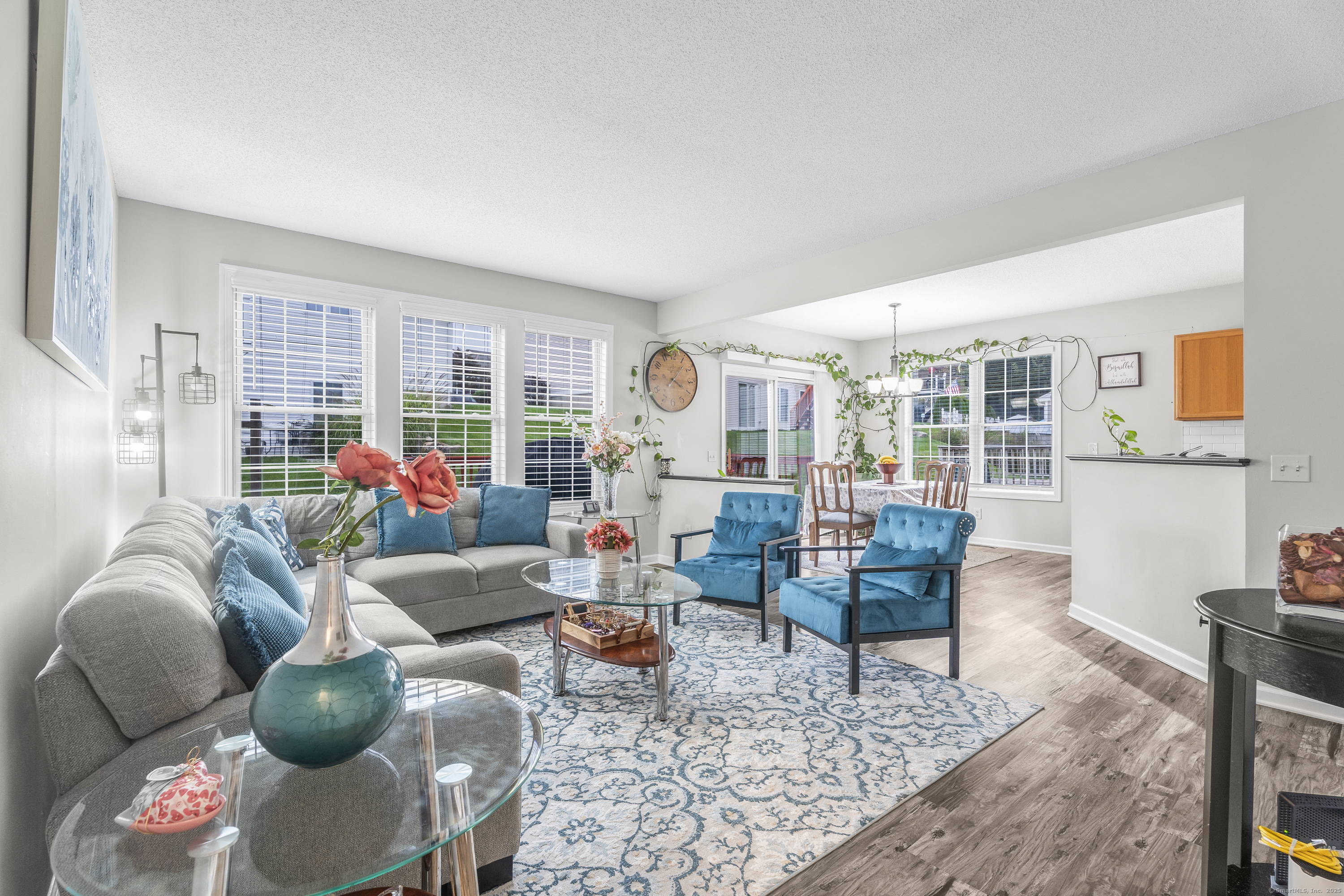 29 Primrose Lane, Unit 29 Suffield, CT 06078 - Photo 7 of 32 a living room with furniture and wooden floor