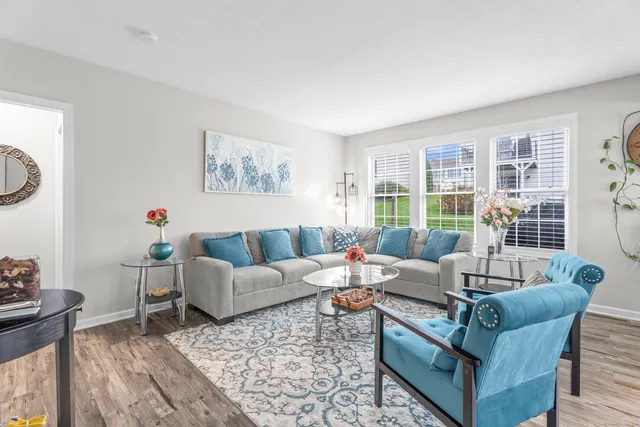 a living room with furniture and a large window