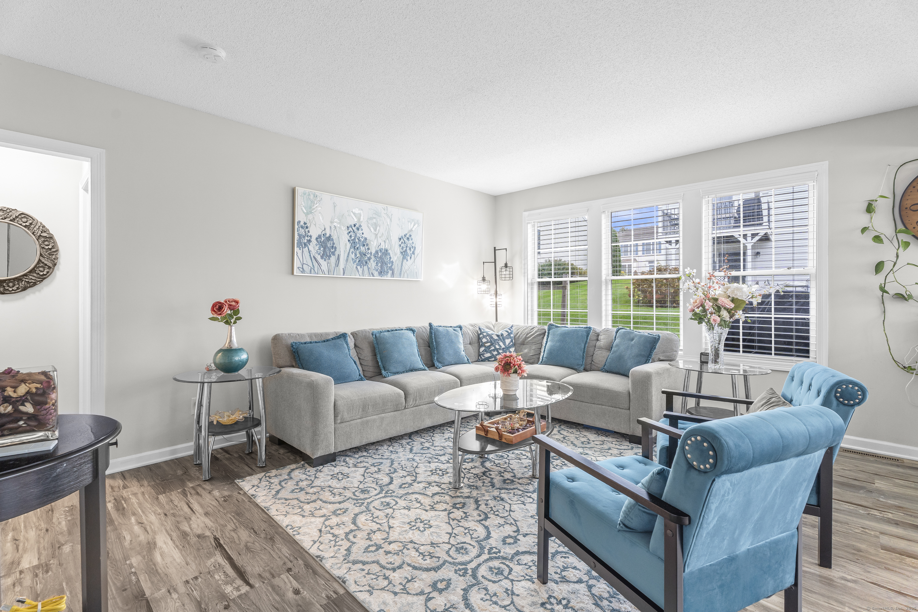 29 Primrose Lane, Unit 29 Suffield, CT 06078 - Photo 8 of 32 a living room with furniture and a large window