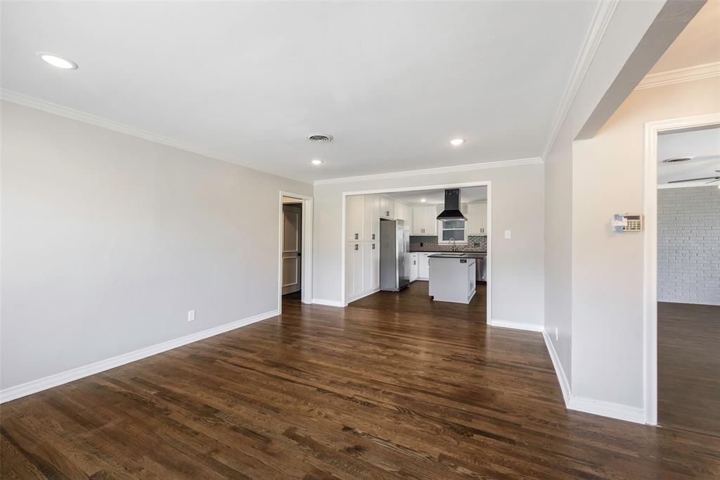 2323 Sutter Street Dallas, TX 75216 - Photo 7 of 30 Unfurnished living room with crown molding, sink, and dark hardwood / wood-style flooring