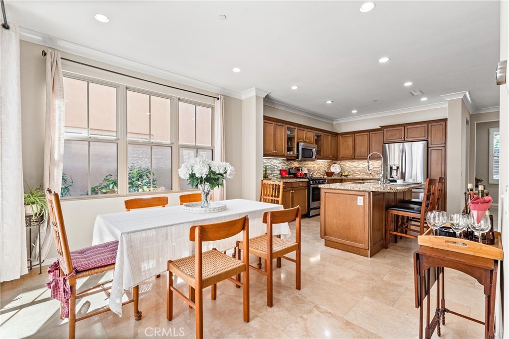 37 Peony Irvine, CA 92618 - Photo 13 of 56 a room with stainless steel appliances kitchen island granite countertop a refrigerator a stove top oven and white cabinets with wooden floors