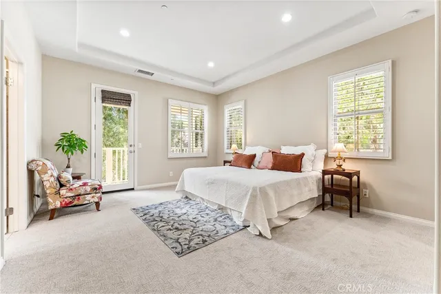 a spacious bedroom with a bed and a couch