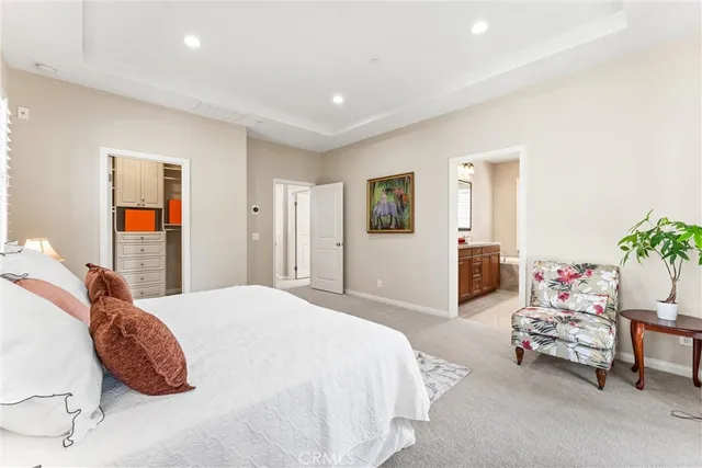 a spacious bedroom with a bed and a couch