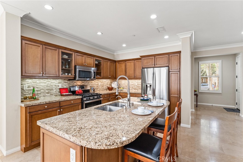 37 Peony Irvine, CA 92618 - Photo 10 of 56 a kitchen with stainless steel appliances granite countertop a stove refrigerator and cabinets