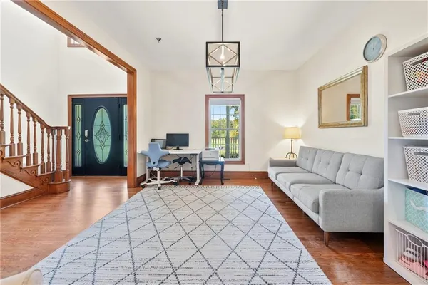 a living room with furniture window and wooden floor