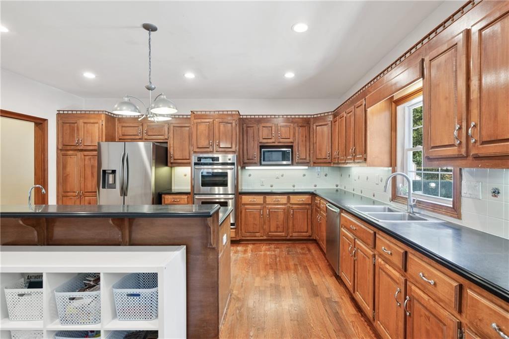 422 Blessings Lane Nicholson, GA 30565 - Photo 20 of 90 a kitchen with stainless steel appliances kitchen island granite countertop a refrigerator a stove top oven and a sink with cabinets