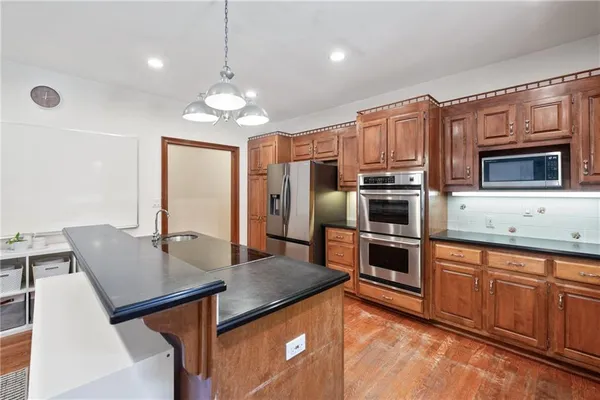a spacious bathroom with a double vanity sink a mirror and a toilet